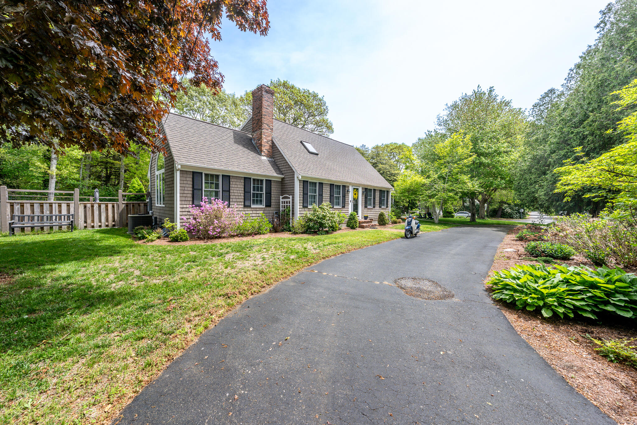 61 Angus Way Centerville, MA 02632 - Photo 5 of 59 a front view of a house with a yard and shrubs