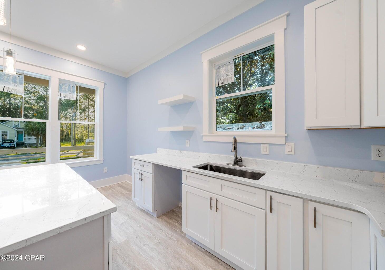 103 7th Street Santa Rosa Beach, FL 32459 - Photo 8 of 27 a kitchen with a sink cabinets and window