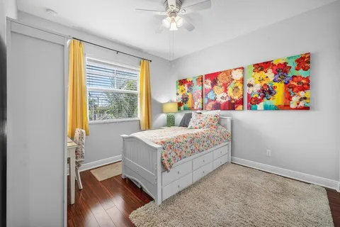 a bedroom with a bed and a painting on the wall