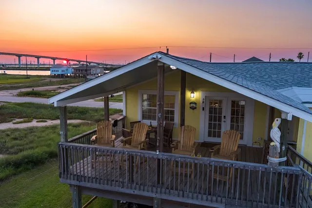 a view of a wooden chairs on the roof deck