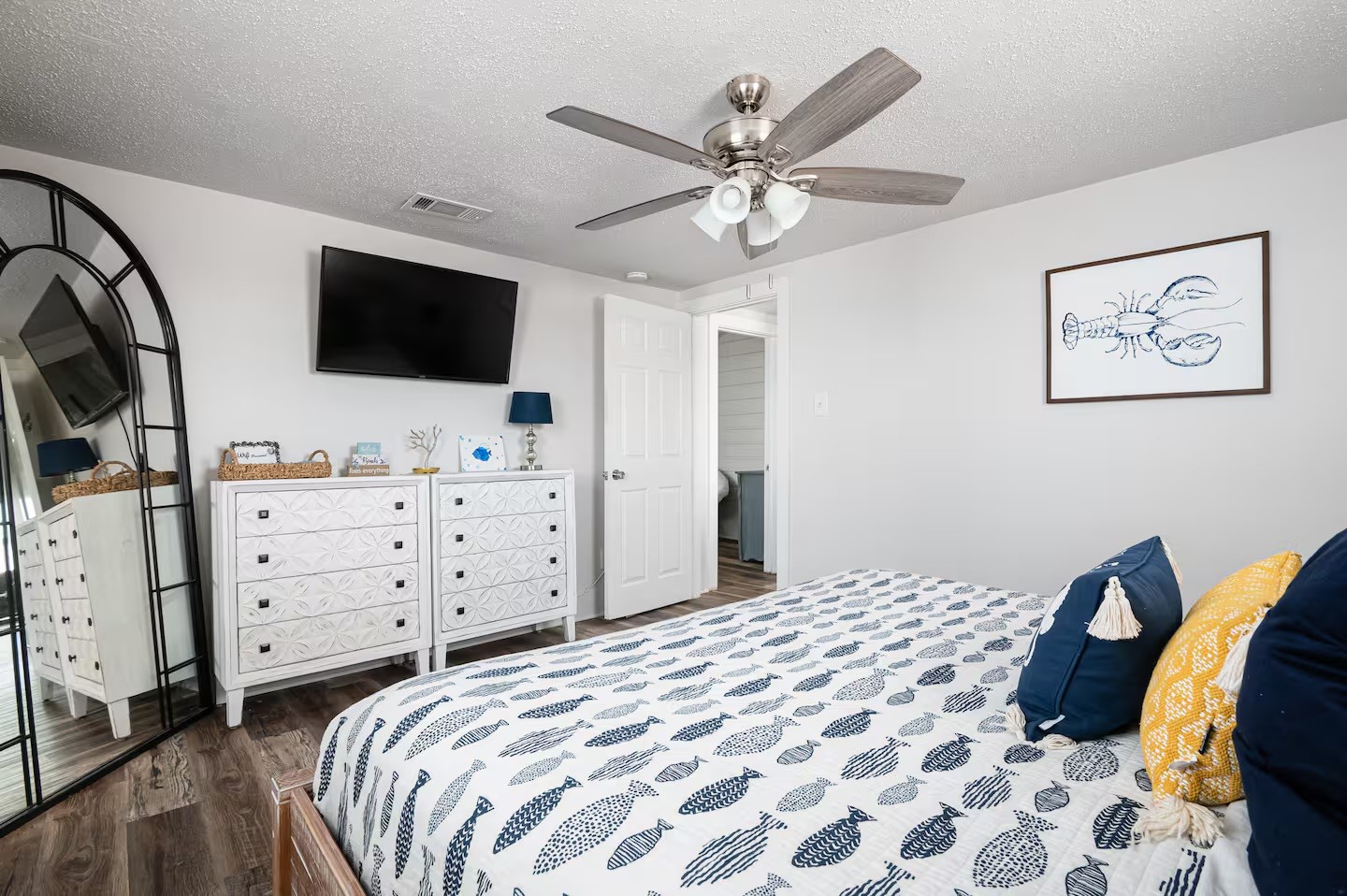 310 Shark Lane Surfside Beach, TX 77541 - Photo 15 of 33 a bedroom with a large bed and a flat tv screen on dresser