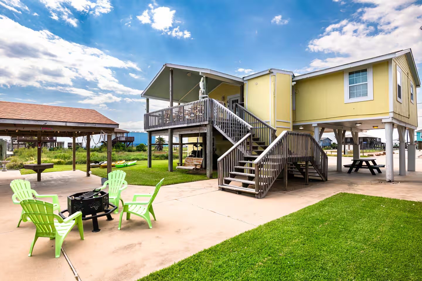 310 Shark Lane Surfside Beach, TX 77541 - Photo 19 of 33 a view of a patio with a table and chairs under an umbrella
