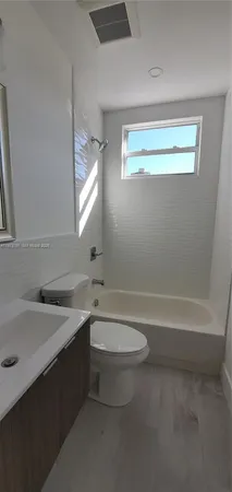 a bathroom with a sink a toilet and a bathtub