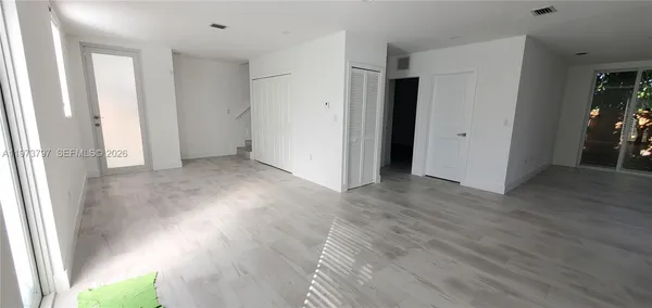 a view of hallway with wooden floor