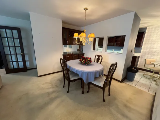 a view of a dining room with furniture and window