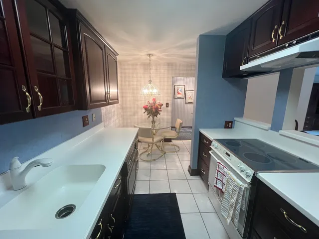 a kitchen with a sink stove and cabinets