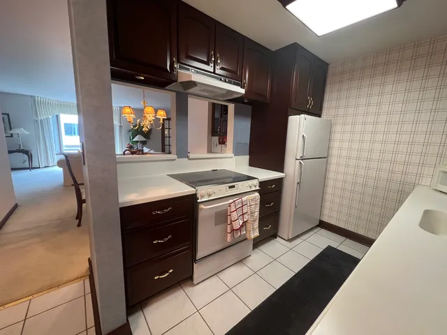 a kitchen with a refrigerator and a stove