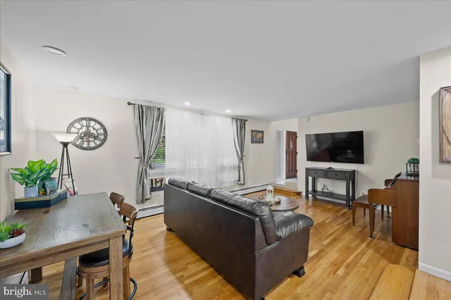 a dining room with furniture and wooden floor