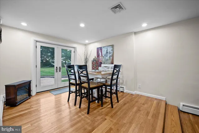 a kitchen with a dining table chairs and refrigerator