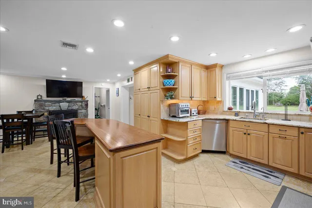 a dining room with furniture and a flat screen tv