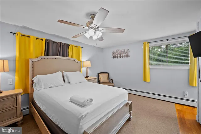 a bathroom with a toilet sink a mirror and vanity