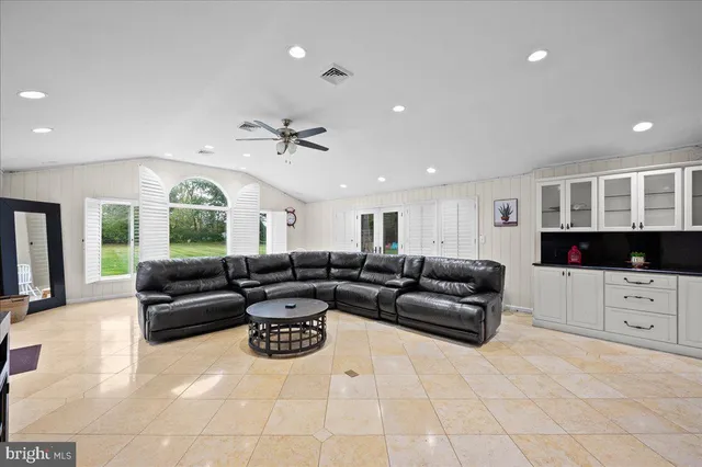 a living room with furniture and a lamp