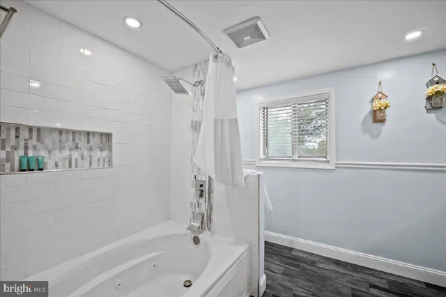 a bedroom with furniture and a flat screen tv