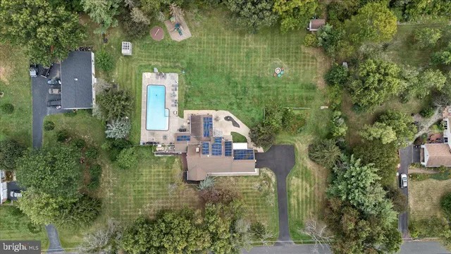 an aerial view of house with yard swimming pool and outdoor seating
