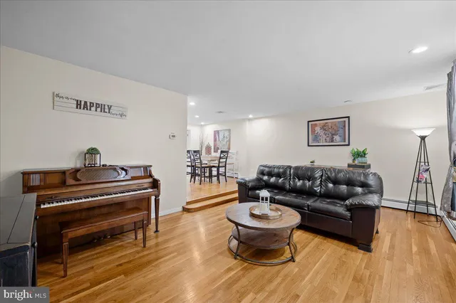 a living room with furniture and a piano