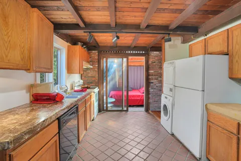 a kitchen with stainless steel appliances granite countertop a refrigerator a sink and a stove