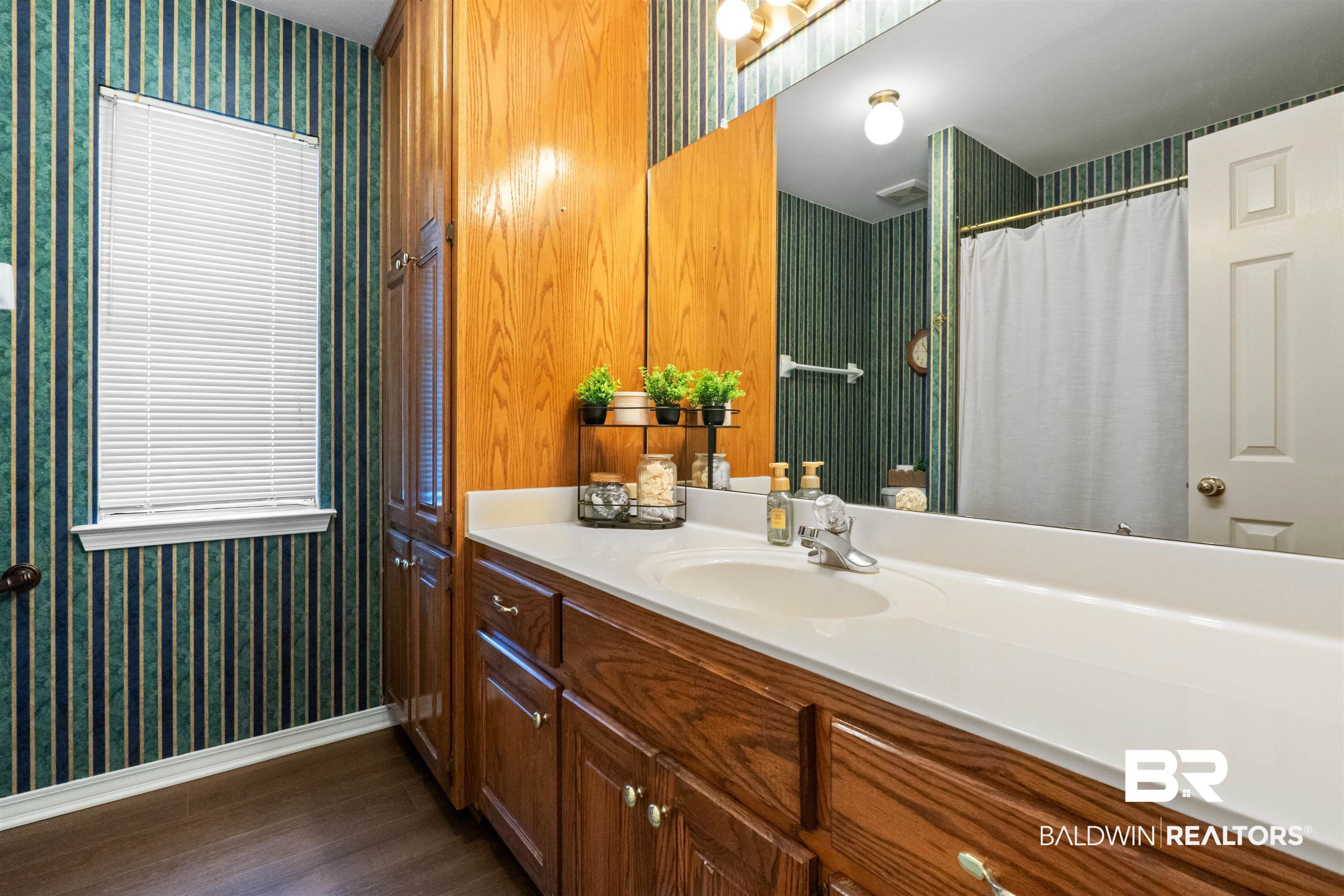 153 Lakeview Loop Daphne, AL 36526 - Photo 41 of 56 An extended vanity provides ample space for busy mornings while offering plenty of storage for everyday essentials.