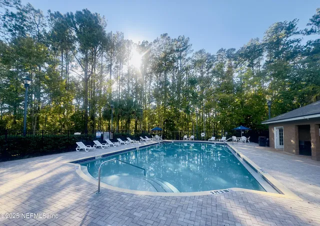 swimming pool view with a seating space