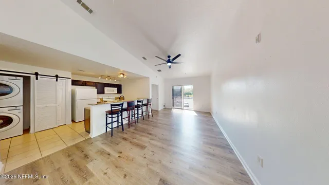 a view of a livingroom with furniture and a ceiling fan