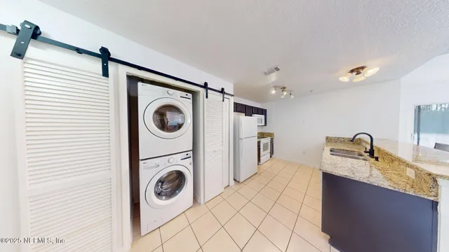 a utility room with sink dryer and washer