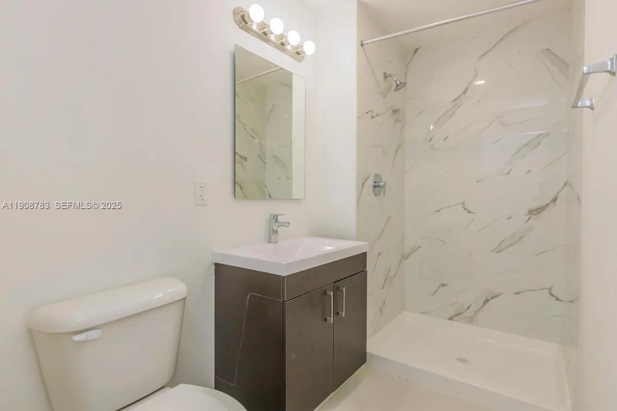 25850 Southwest 140th Court, Unit 7506 Homestead, FL 33032 - Photo 12 of 24 a bathroom with a sink a toilet and shower