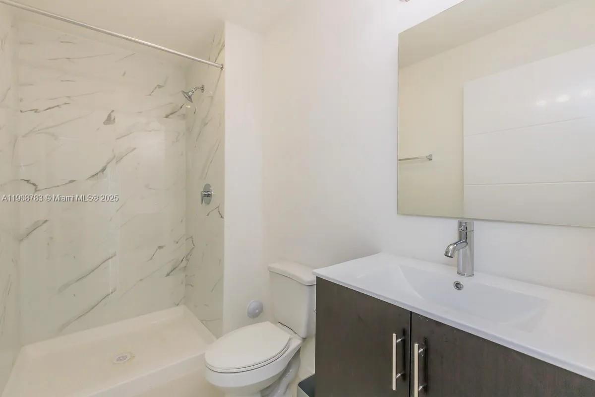 25850 Southwest 140th Court, Unit 7506 Homestead, FL 33032 - Photo 8 of 24 a bathroom with a sink a toilet and shower