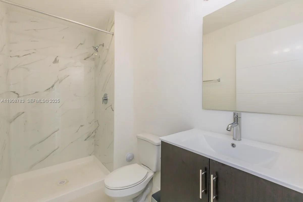 25850 Southwest 140th Court, Unit 7506 Homestead, FL 33032 - Photo 8 of 24 a bathroom with a sink a toilet and shower