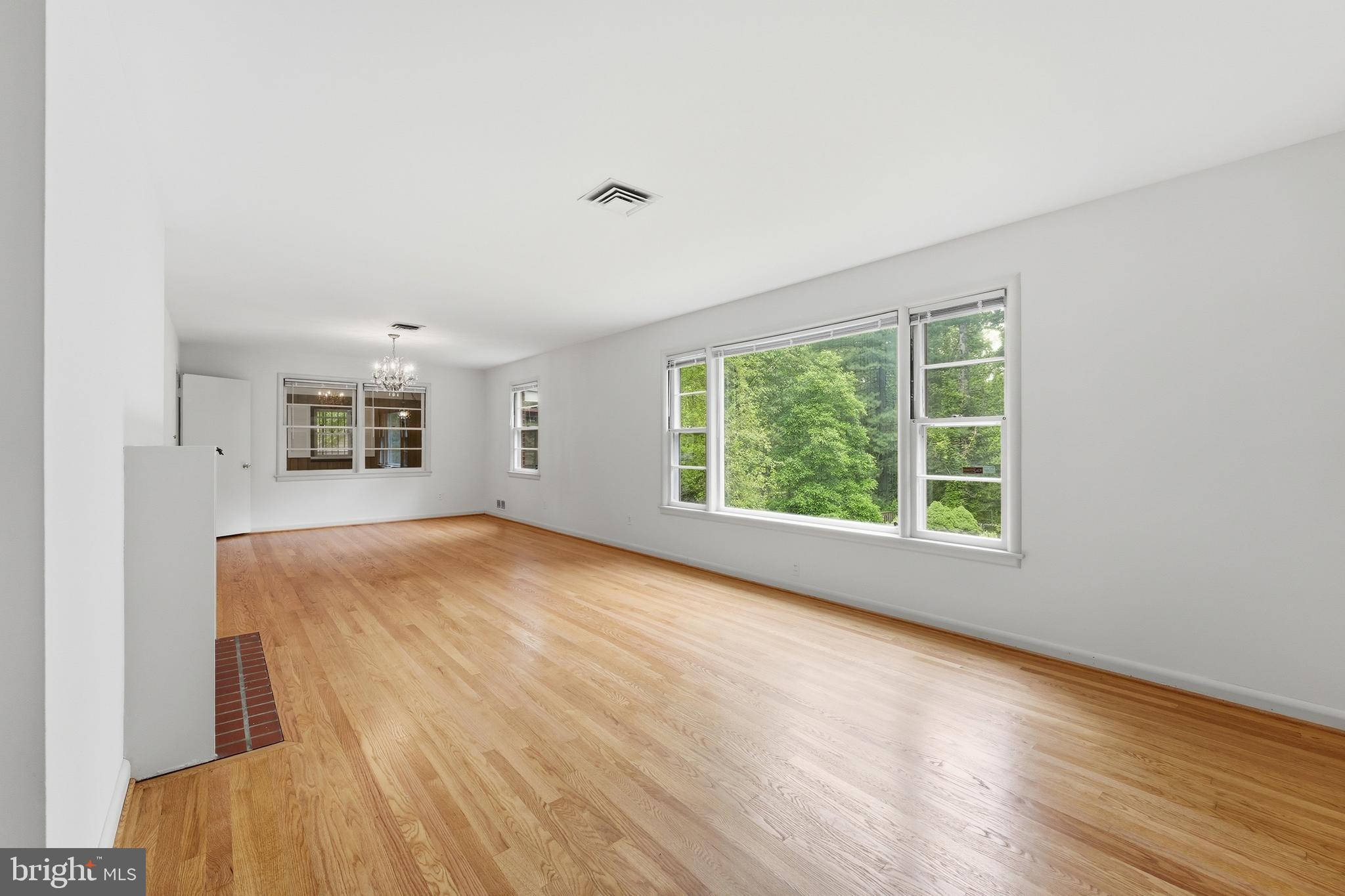 228 Northwest Terrace Silver Spring, MD 20901 - Photo 16 of 70 a view of an empty room with a window and wooden floor