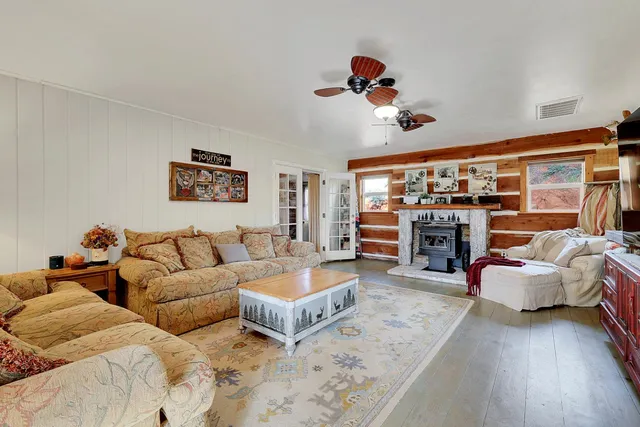 a view of front door with wooden floor and mirror