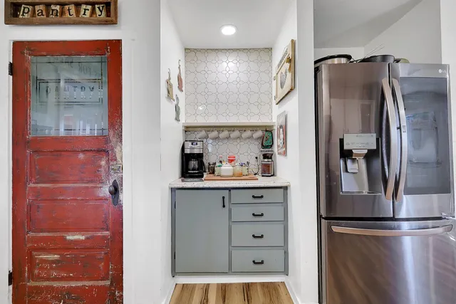 a kitchen with stainless steel appliances granite countertop a refrigerator and a sink