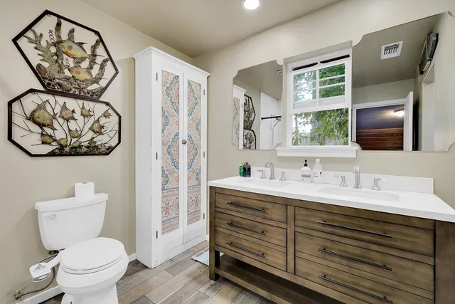 a view of a patio with couches table and chairs and potted plants