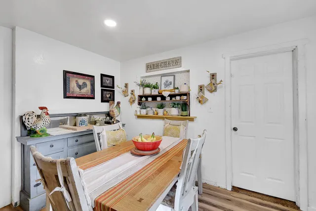 a front view of a house with a yard and trees