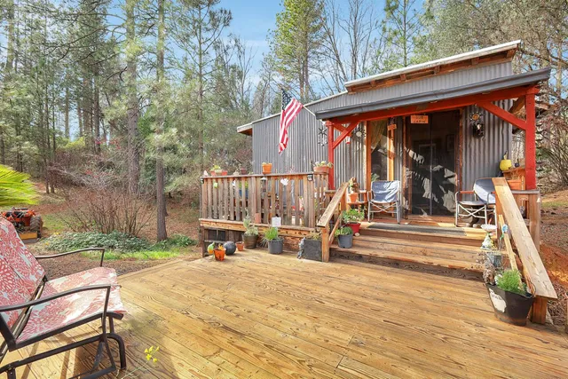 a backyard of a house with barbeque oven table and chairs