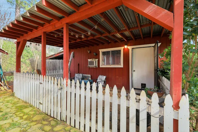 a view of a patio with chair and tables back yard of the house