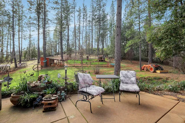 a view of a kitchen with refrigerator and wooden floor