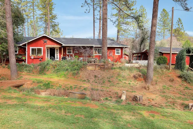 a kitchen with stainless steel appliances granite countertop a stove top oven a sink a refrigerator white cabinets and wooden floor