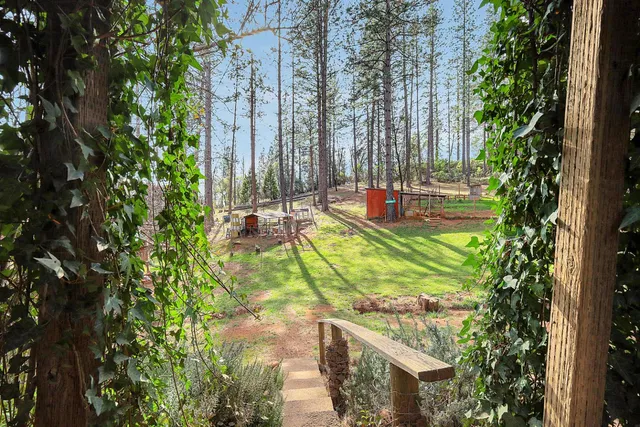 a kitchen and a dining table with wooden floor