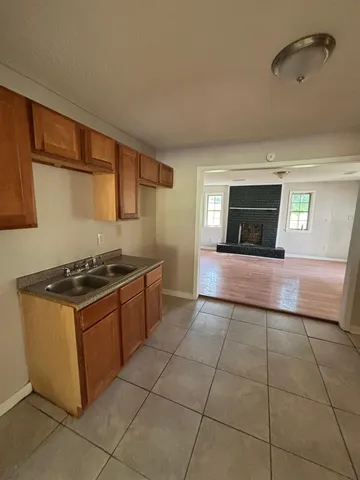 a kitchen with granite countertop a stove a sink and a microwave