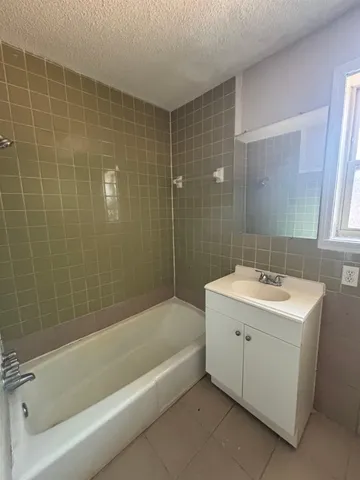 a bathroom with a sink mirror toilet and bathtub