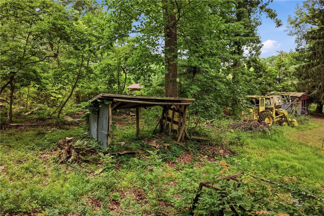 3573 Lower Saucon Road Hellertown, PA 18055 - Photo 48 of 56 Mature trees surround rustic outbuildings on this wooded property.
