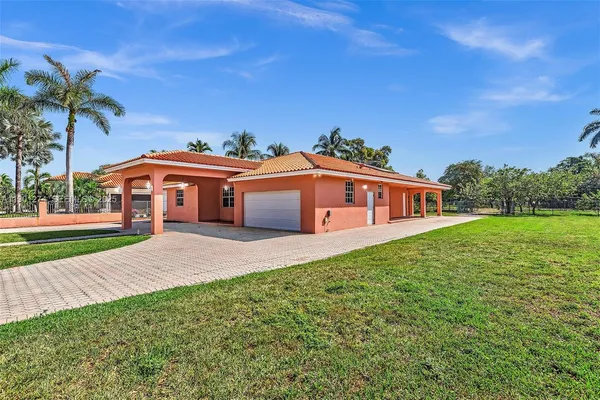 a front view of house with yard and green space