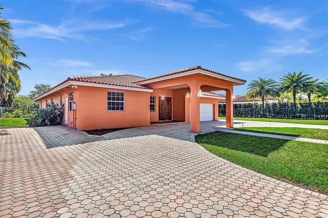 a view of a dining room with furniture and a chandelier