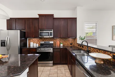 a kitchen with a sink stove and refrigerator