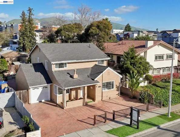 a aerial view of a house next to a yard