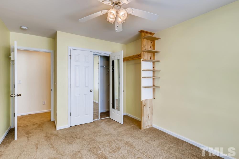 4906 Ravel Stone Court Raleigh, NC 27610 - Photo 22 of 28 an empty room with windows and ceiling fan