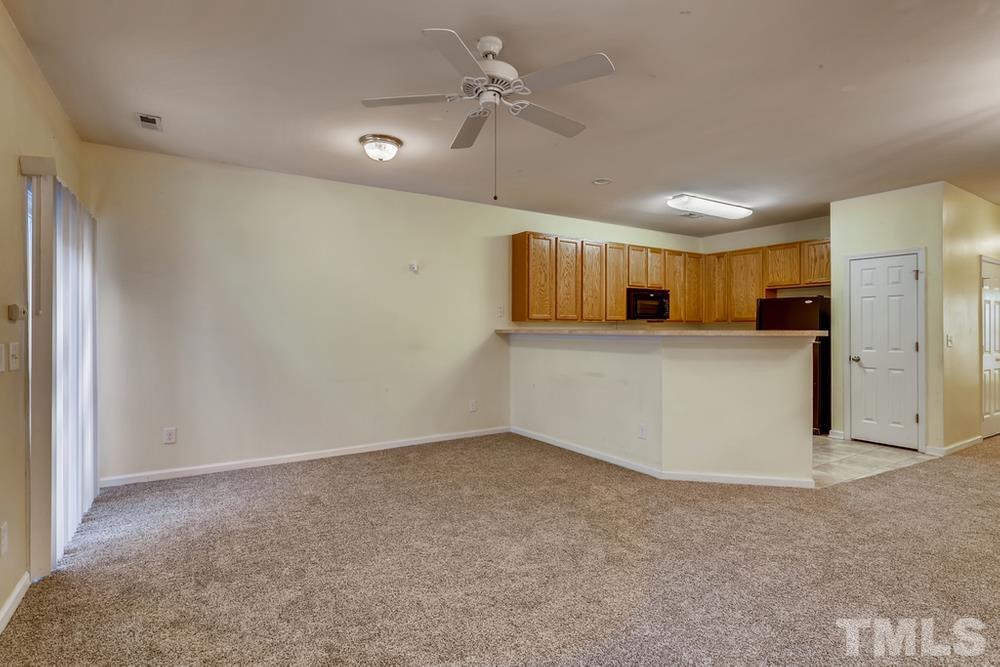 4906 Ravel Stone Court Raleigh, NC 27610 - Photo 5 of 28 a view of a kitchen with a sink and cabinets