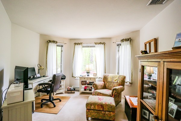 18 Saddle Hill Road Boxford, MA 01921 - Photo 11 of 20 a living room with furniture a flat screen tv and a window
