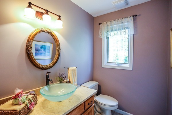 18 Saddle Hill Road Boxford, MA 01921 - Photo 12 of 20 a bathroom with a toilet a sink and a mirror