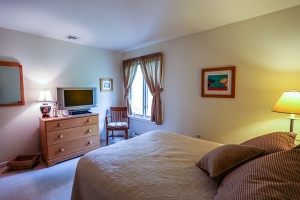 18 Saddle Hill Road Boxford, MA 01921 - Photo 14 of 20 a bedroom with a bed and a flat screen tv