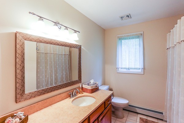 18 Saddle Hill Road Boxford, MA 01921 - Photo 15 of 20 a bathroom with a sink vanity mirror and toilet